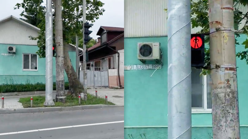 Semafor pentru pietoni, ascuns după un stâlp la o intersecție din Chișinău